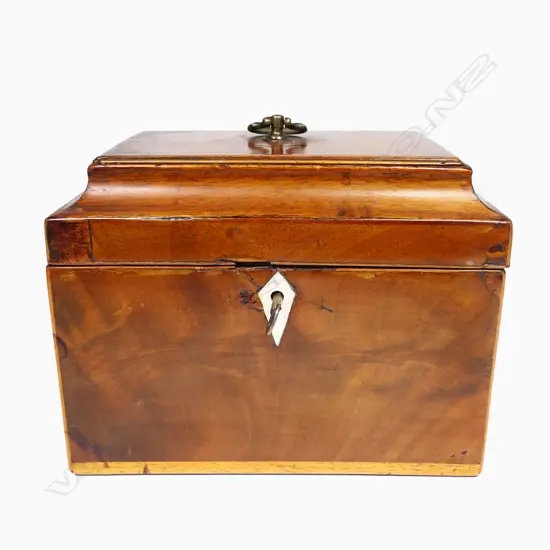 A 19thC small proportioned, flame mahogany veneered, sarcophagus lidded tea caddy - Opening to reveal two sarcophagi sliding lidded, removeable canisters, with pale timber stringing. With key.170 x 115 x 130mm.