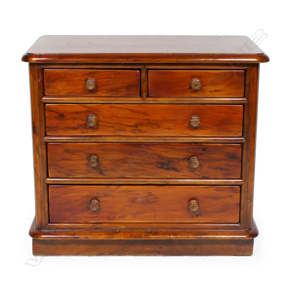 A late 19thC New Zealand colonial solid mottled kauri apprentice type chest - two short over three long graduating drawers, knob handles, one chipped, a similar replacement available. Plinth base, plain kauri top with thumb moulded edge. 360 x 200 x 330mm. Please note: The foot and back boards are later replacements Image 1++
