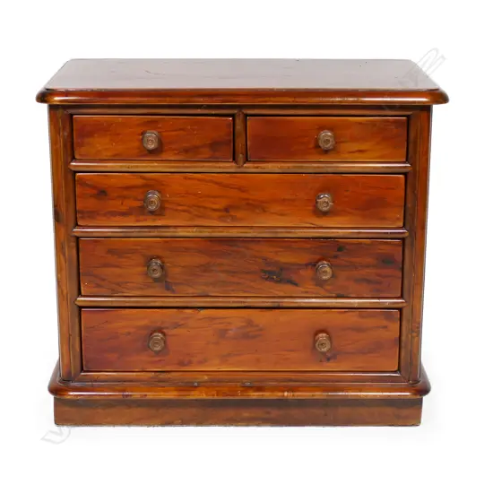 A late 19thC New Zealand colonial solid mottled kauri apprentice type chest - two short over three long graduating drawers, knob handles, one chipped, a similar replacement available. Plinth base, plain kauri top with thumb moulded edge. 360 x 200 x 330mm. Please note: The foot and back boards are later replacements