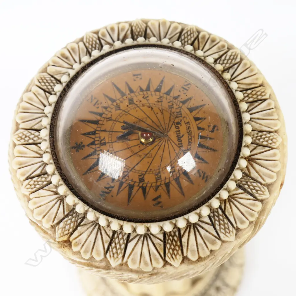 An uncommon William IV carved ivory desk top combination sundial compass thermometer - with paper plateau, signed 'C Essex & Co, London' under glass dome, the tapered column with glass thermometer framed by engraved scale. The top and base rims with panel carved, leaf and bead decoration. H.160mm. Image 1++