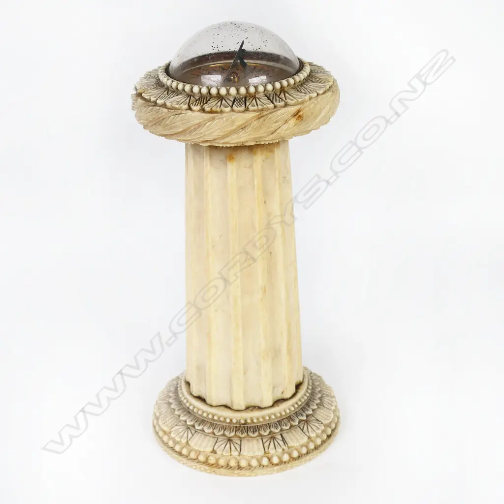 An uncommon William IV carved ivory desk top combination sundial compass thermometer - with paper plateau, signed 'C Essex & Co, London' under glass dome, the tapered column with glass thermometer framed by engraved scale. The top and base rims with panel carved, leaf and bead decoration. H.160mm. Image 1++