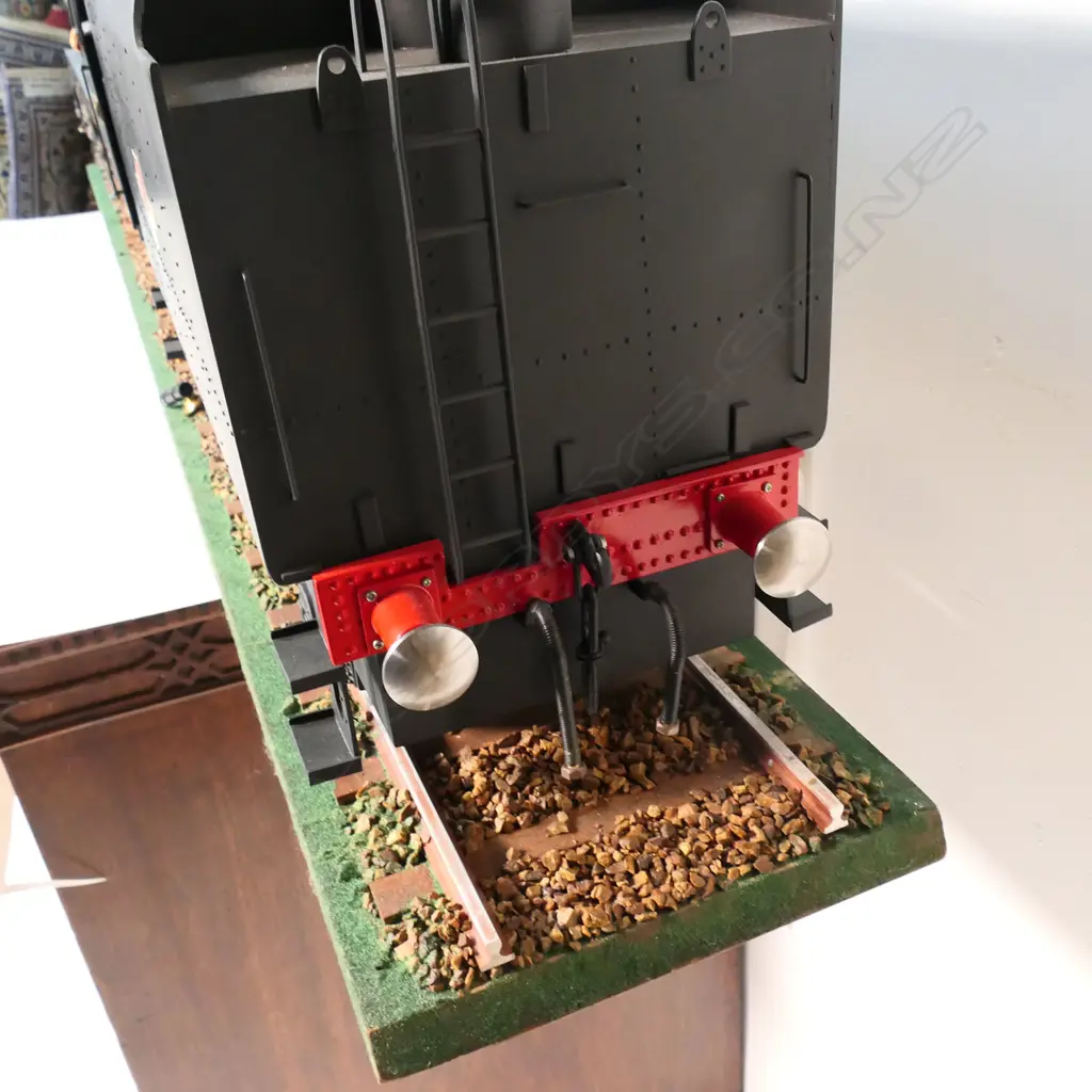 A large cased model of a steam train 'Evening Star 92220’ - on realistic track, together with a book and print. 1850 x 240 x 455mm. Provenance: Made by John Borrows, an Auckland engineer who was the brains behind Fisher & Paykel's revolutionary SmartDrive washing machine. In Mr Borrows’ spare time he was a model maker. Image 1++