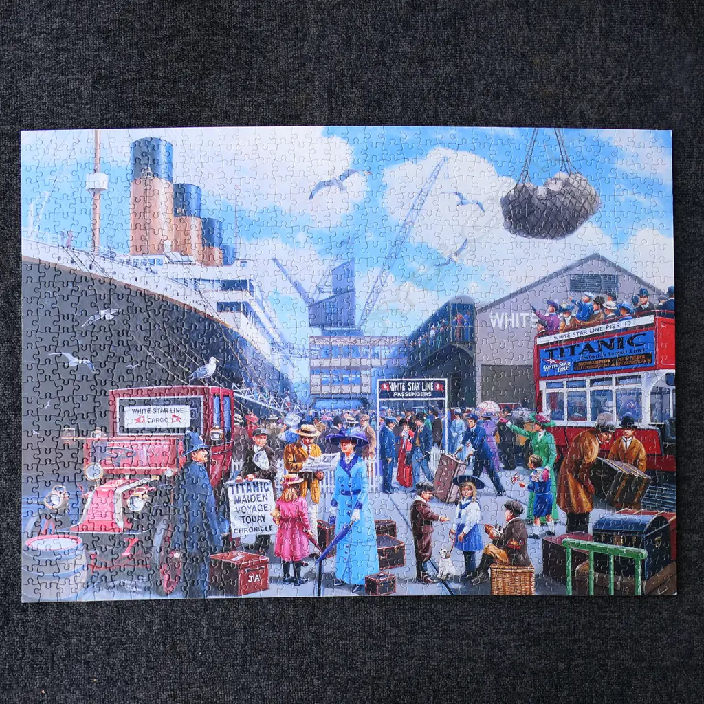 A model of RMS Titanic - on mirrored base and table, together with eight Titanic books and a jigsaw puzzle. L.1375mm. Image 1++