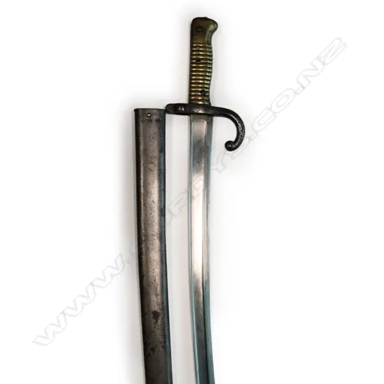 A 19thC French bayonet - fullered blade, dated 1873, hooked quillon, with scabbard. L.700mm.
