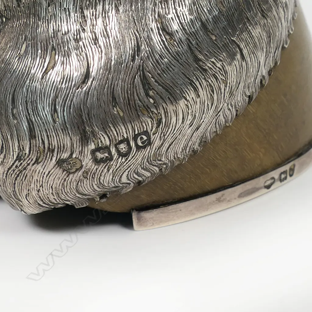 An historic Boer War presentation silver mounted horses hoof inkwell - the applied silver shield presentation engraved with multiple names including Lt. Col. F.C. Bethune Major, Major R.L.Walter and 31 other names. The silver top with missing attachment and small lidded inkwell above an applied silver mount modelled and engraved as horses hair. Silver horse shoe to the base. Image 1++