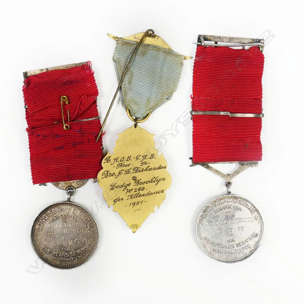 A rare set of medals to an Auckland fireman John Leslie Bernard Bishenden - of the Auckland Metropolitan Fire Brigade. Born 20 Mar 1926 and died at Howick 15 Jun 1970 (aged 44). 1963 dated UFBA Medal with 3 bars and very rare Auckland Fire Board Medal with one bar. Together with medal from the Buffalo Lodge Image 1++