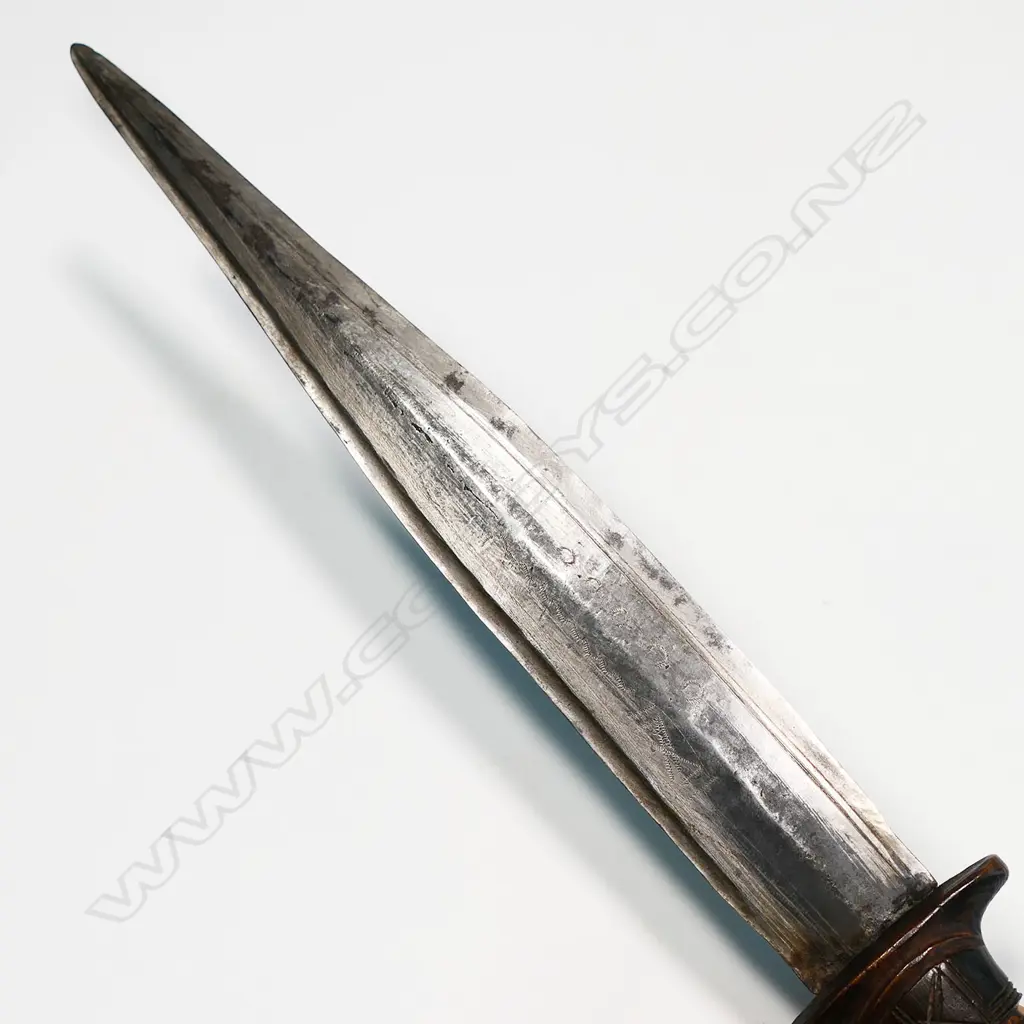 An African dagger - stitched leather scabbard and carved wood handle, straight double edge blade with fine etched cross hatched engraving. L.390mm. Image 1++