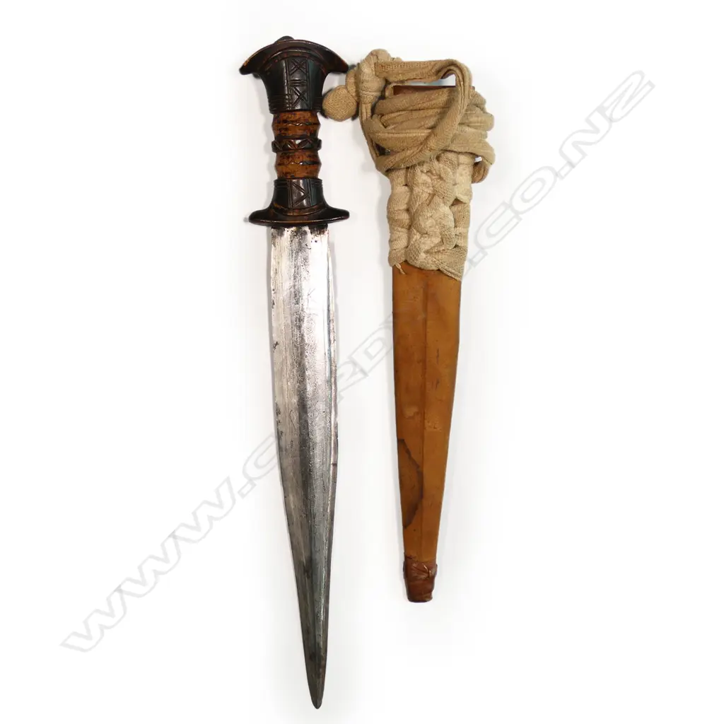 An African dagger - stitched leather scabbard and carved wood handle, straight double edge blade with fine etched cross hatched engraving. L.390mm. Image 1++