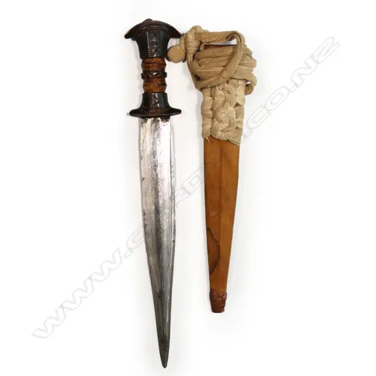 An African dagger - stitched leather scabbard and carved wood handle, straight double edge blade with fine etched cross hatched engraving. L.390mm.
