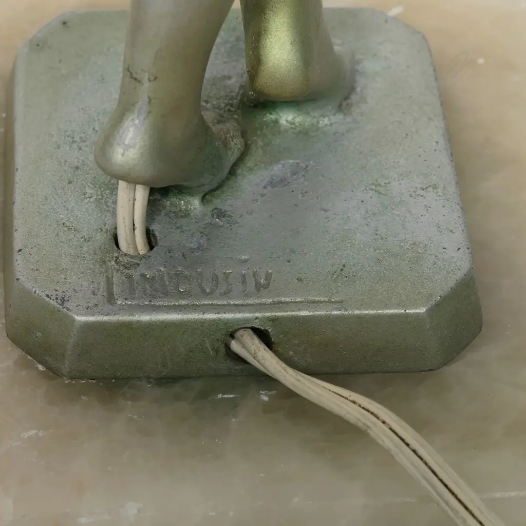 An Art Deco cold-painted silvered spelter nude figured table lamp, by Jacques Limousin, c.1930s - the athletic figure holds a white glass spherical shade above her head, signed to the base 'Limousin', raised on alabaster plinth. Overall H.600mm. some small losses to Image 1++