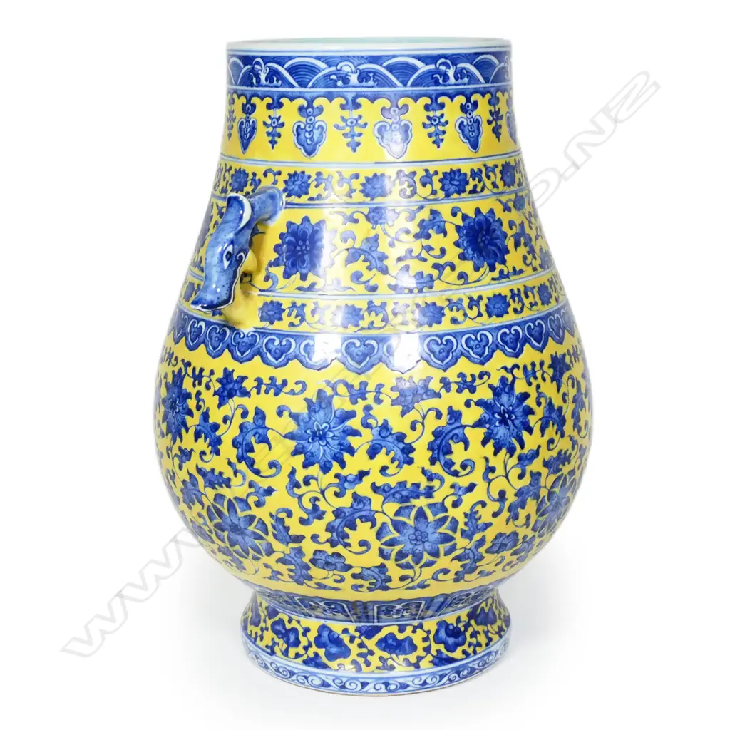 A large Chinese porcelain vase - round spreading foot, bulbous ovoid form, blue trailing flowering vines on a mustard yellow ground, shoulder handles in the form of mythical beast heads, glazed turquoise interior. H.370mm. Image 1++