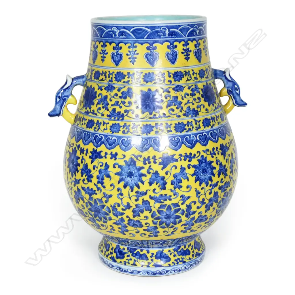 A large Chinese porcelain vase - round spreading foot, bulbous ovoid form, blue trailing flowering vines on a mustard yellow ground, shoulder handles in the form of mythical beast heads, glazed turquoise interior. H.370mm. Image 1++