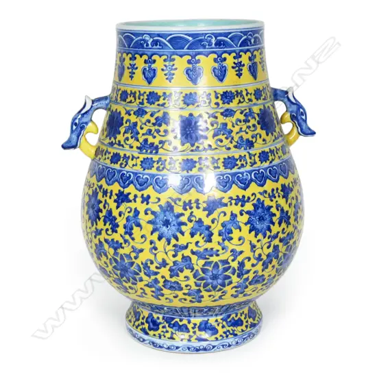 A large Chinese porcelain vase - round spreading foot, bulbous ovoid form, blue trailing flowering vines on a mustard yellow ground, shoulder handles in the form of mythical beast heads, glazed turquoise interior. H.370mm.