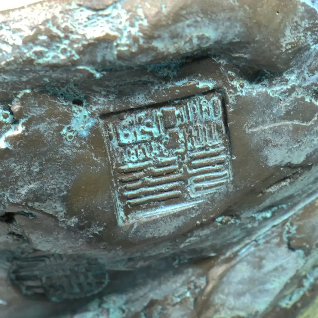 A highly decorative and energetic bronze of a bodhisattva Shaolin monk - wielding his khakkhara staff in his raised arm and manifesting a flaming pearl in his left hand, stamped under the hem of his flaring cloak with two undeciphered zhuanshu script seal marks. The surface treatments including cold painting and enhanced verdigris patination. The poised stance above rising and falling waves mirroring the Buddhist concept of finding balance and equanimity amidst change, the ebb and flow - life and death. H.1010mm, Image 1++