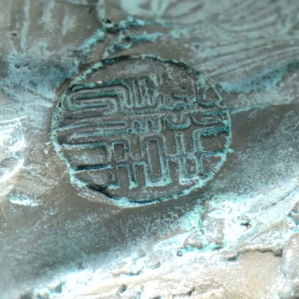 A highly decorative and energetic bronze of a bodhisattva Shaolin monk - wielding his khakkhara staff in his raised arm and manifesting a flaming pearl in his left hand, stamped under the hem of his flaring cloak with two undeciphered zhuanshu script seal marks. The surface treatments including cold painting and enhanced verdigris patination. The poised stance above rising and falling waves mirroring the Buddhist concept of finding balance and equanimity amidst change, the ebb and flow - life and death. H.1010mm, Image 1++