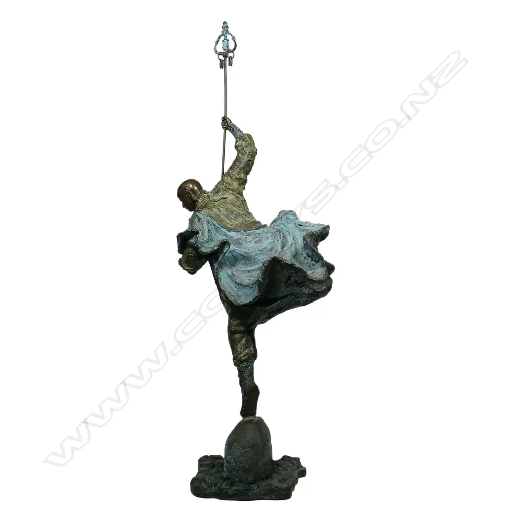 A highly decorative and energetic bronze of a bodhisattva Shaolin monk - wielding his khakkhara staff in his raised arm and manifesting a flaming pearl in his left hand, stamped under the hem of his flaring cloak with two undeciphered zhuanshu script seal marks. The surface treatments including cold painting and enhanced verdigris patination. The poised stance above rising and falling waves mirroring the Buddhist concept of finding balance and equanimity amidst change, the ebb and flow - life and death. H.1010mm, Image 1++