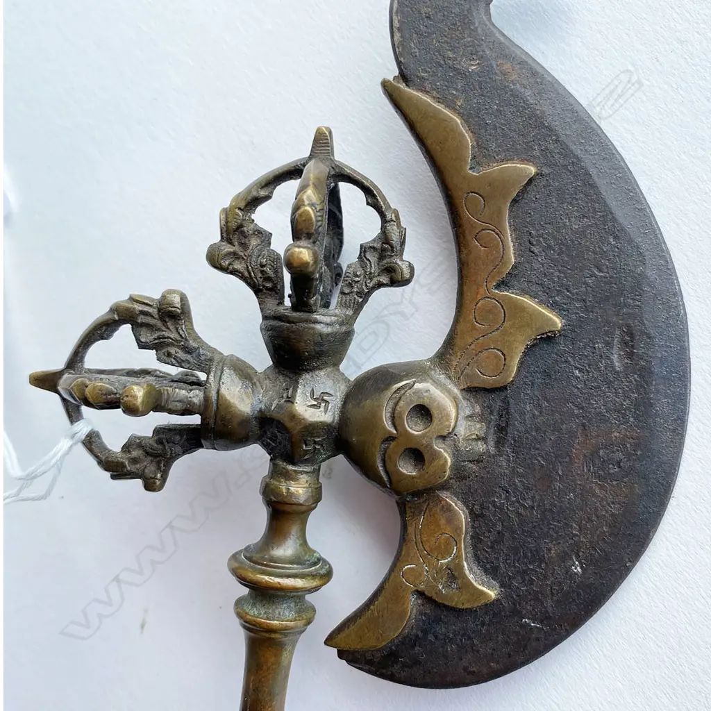 A Tibetan Buddhist kartika (ceremonial knife) on ornate axe shaft, 19thC - steel crescent blade set in bronze mounts incorporating swastika engraved octagon mount and vajra terminals on a double baluster knopped shaft. L.340mm. Image 1++