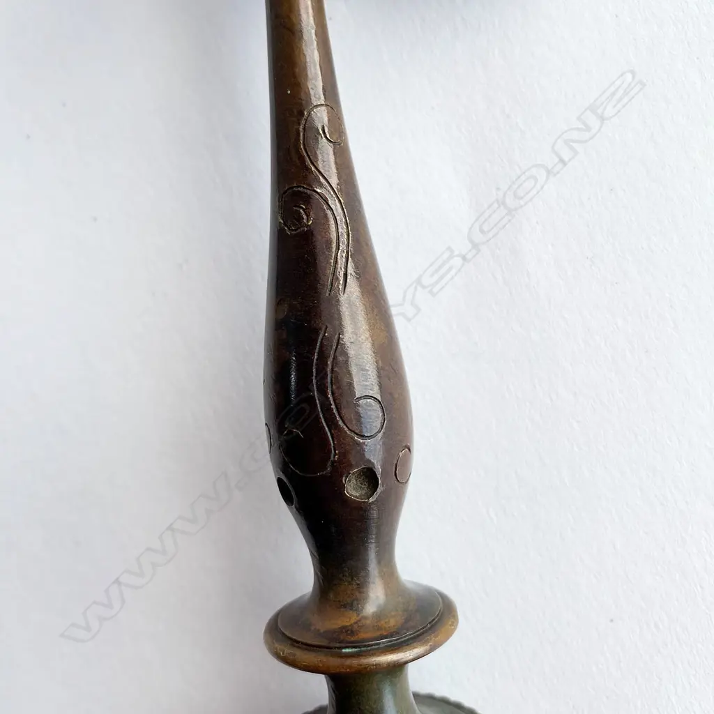 A Tibetan Buddhist kartika (ceremonial knife) on ornate axe shaft, 19thC - steel crescent blade set in bronze mounts incorporating swastika engraved octagon mount and vajra terminals on a double baluster knopped shaft. L.340mm. Image 1++