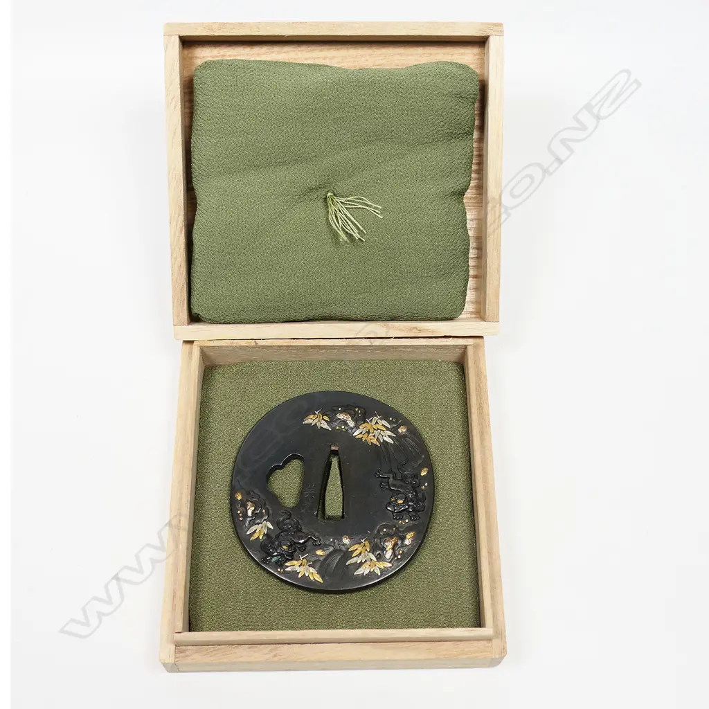 A superb late 18thC/early 19thC Japanese Shibuichi soft metal tsuba - quality high relief gambolling Shishi playing in a waterfall, with gold and silver highlighted foliage. Signed Terumitsu. In fitted box. Image 1++