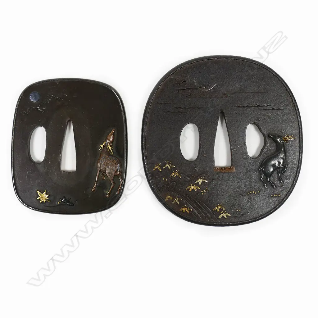 A superb pair of 19thC Daisho tsuba - the Dai in iron with raised rim showing a Shibuichi stag in relief by a river under a silver crescent moon, gold highlights on foliage to the front and reverse. The Sho in Shiboichi with raised deer in copper with gold antlers under a silver full moon behind clouds. Gold and Shakudo maple leaves on front and reverse. In fitted box. Image 1++