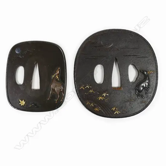 A superb pair of 19thC Daisho tsuba - the Dai in iron with raised rim showing a Shibuichi stag in relief by a river under a silver crescent moon, gold highlights on foliage to the front and reverse. The Sho in Shiboichi with raised deer in copper with gold antlers under a silver full moon behind clouds. Gold and Shakudo maple leaves on front and reverse. In fitted box.