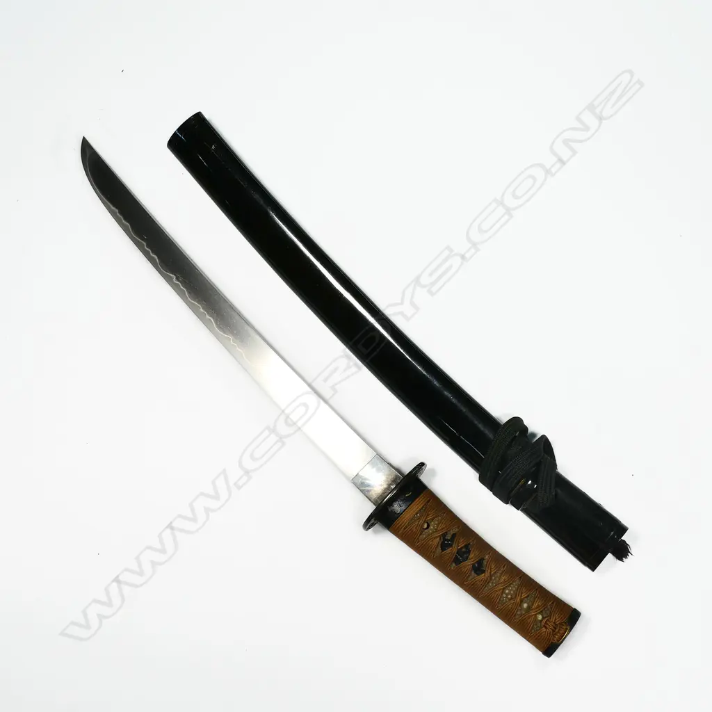 A Japanese late 18th/early 19thC tanto - unsigned Hirazukuri blade in good polish with midare temper. Nice old mounts in excellent condition. Shakudo Tsuba, Fuchi Kashera with heron and figure with gold highlights, Shakudo double horse menuki. Fine black lacquer Saya with sash cord. Original old sword silk bag showing wear. L.530mm. Image 1++