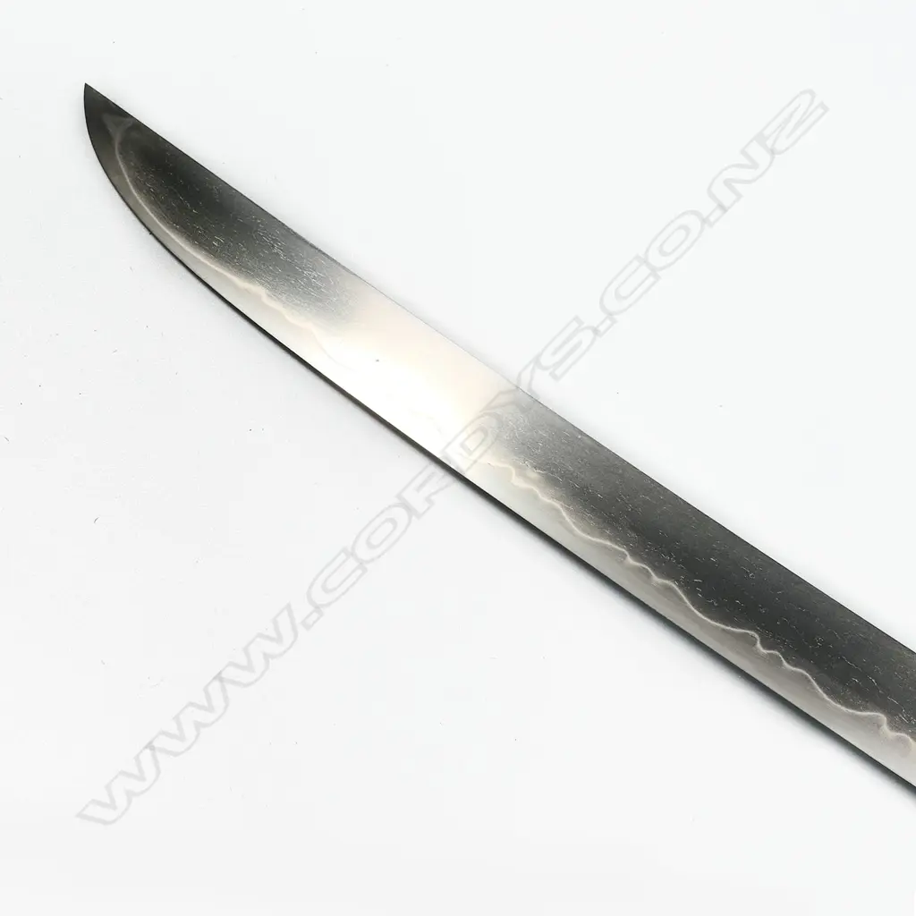 A Japanese late 18th/early 19thC tanto - unsigned Hirazukuri blade in good polish with midare temper. Nice old mounts in excellent condition. Shakudo Tsuba, Fuchi Kashera with heron and figure with gold highlights, Shakudo double horse menuki. Fine black lacquer Saya with sash cord. Original old sword silk bag showing wear. L.530mm. Image 1++