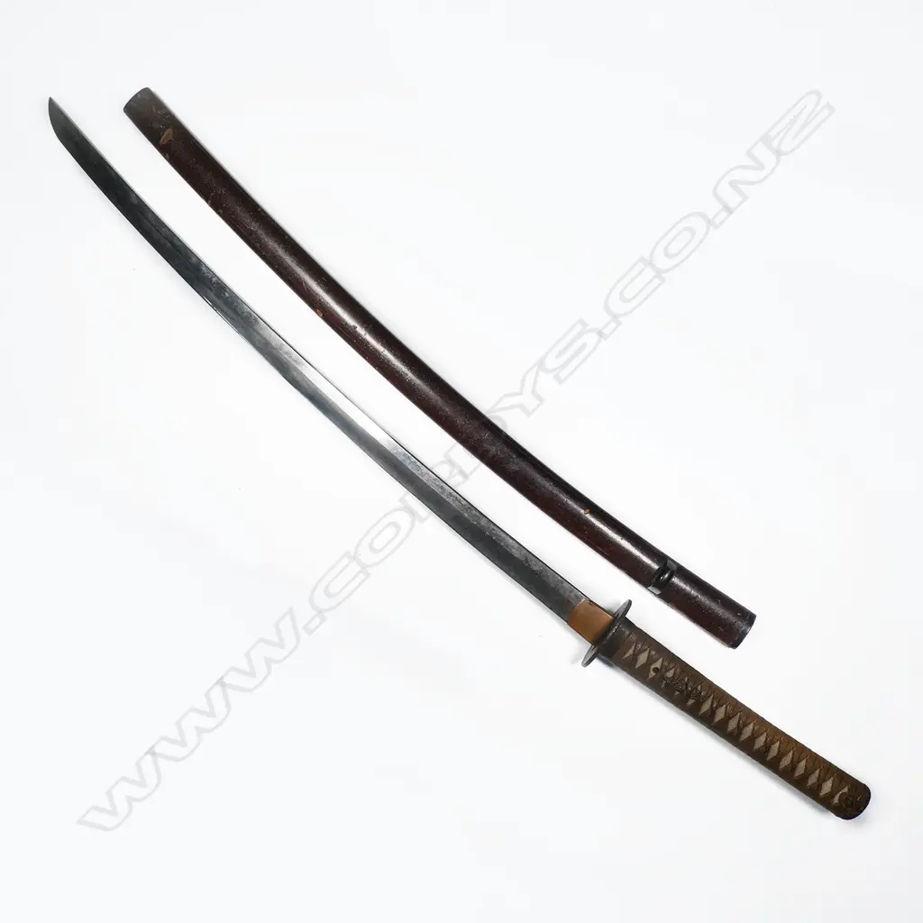 A Japanese katana - with cloth bound ray skin covered hilt with menuki, the tang with single fixing hole, tsuba with landscape decoration. Small area of pitting to blade and other slight oxidation. Blade L.710mm. Overall in lacquer scabbard with some faults 1050mm. Image 1++