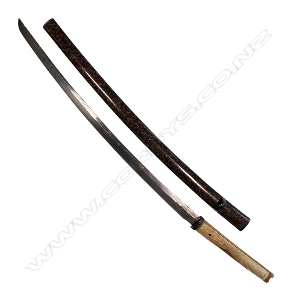 A Japanese katana blade in lacquer saya - L.610mm blade with few areas of surface oxidisation, unsigned tang with three fixing holes, hilt lacking all mounts except fuchi. Black saya with golden hatched pattern, a long bevel to one side revealing an alternate interior pattern. Overall in saya L.880mm, Image 1++