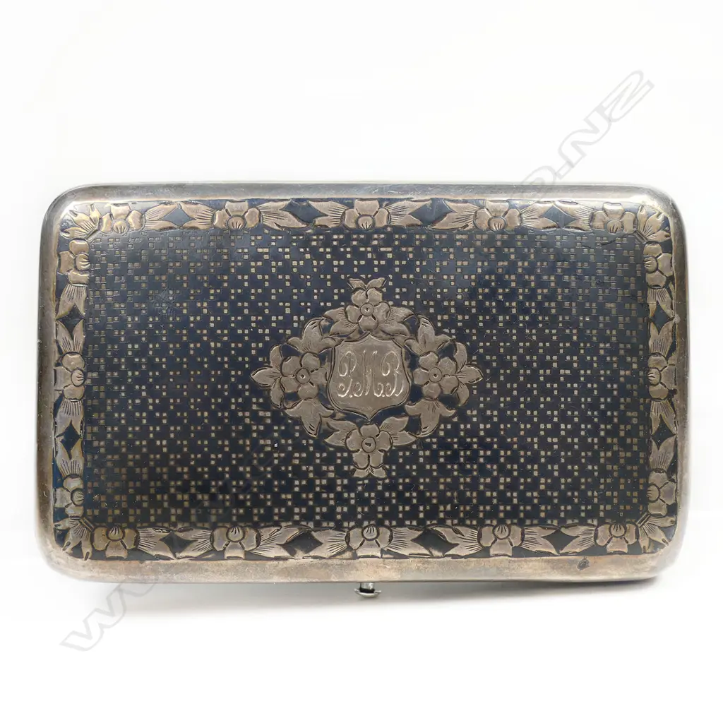 A 19thC Russian niello silver cigar case - finely decorated in a diaper pattern with floral border and framed cartouche. Push button release, the interior with marks for the maker Mikhail Foydorovich Sokolov and Moscow assay master's mark for Victor Vasilyevich Savinsky. 1867. W.120mm. 163gms. Image 1++