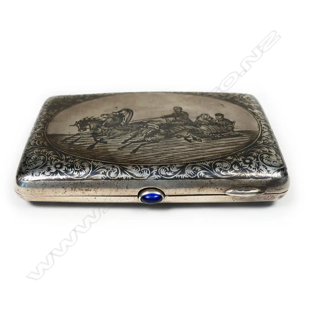 A 19thC Russian niello silver cigarette case - finely decorated with figures in horse drawn sliegh and leafy scrolls. Blue gem to the thumbpiece. Maker's mark for Pyotr Ambrosimov of Moscow 1869 - 1908. Image 1++
