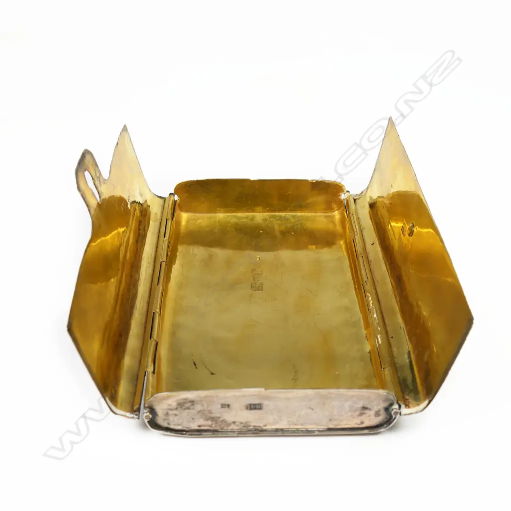 A 18thC Russian silver niello cigar case - of satchel form. The back engraved with a scene of a St. Petersburgh city monument framed by leafy scrolls. Lavishly gilded interior. Marks probably for the maker Fyodor Ivanof and for the assay master Aggey Grigori Svechin, Moscow 1862. W.120mm. 145gms. Image 1++