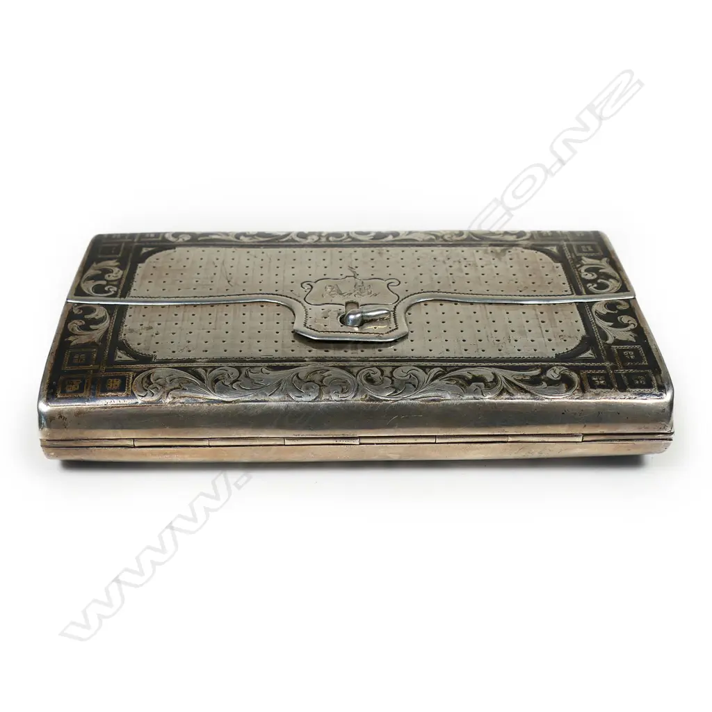 A 18thC Russian silver niello cigar case - of satchel form. The back engraved with a scene of a St. Petersburgh city monument framed by leafy scrolls. Lavishly gilded interior. Marks probably for the maker Fyodor Ivanof and for the assay master Aggey Grigori Svechin, Moscow 1862. W.120mm. 145gms. Image 1++