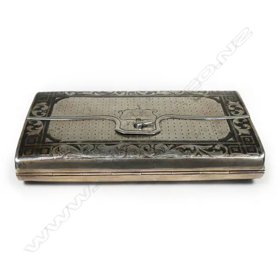 A 18thC Russian silver niello cigar case - of satchel form. The back engraved with a scene of a St. Petersburgh city monument framed by leafy scrolls. Lavishly gilded interior. Marks probably for the maker Fyodor Ivanof and for the assay master Aggey Grigori Svechin, Moscow 1862. W.120mm. 145gms.
