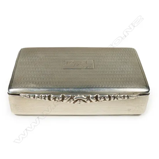An early 20thC silver Georgian style snuff box - finely machine engraved and with applied floral cast tapered thumb piece. London 1926. W.79mm. 82gms.