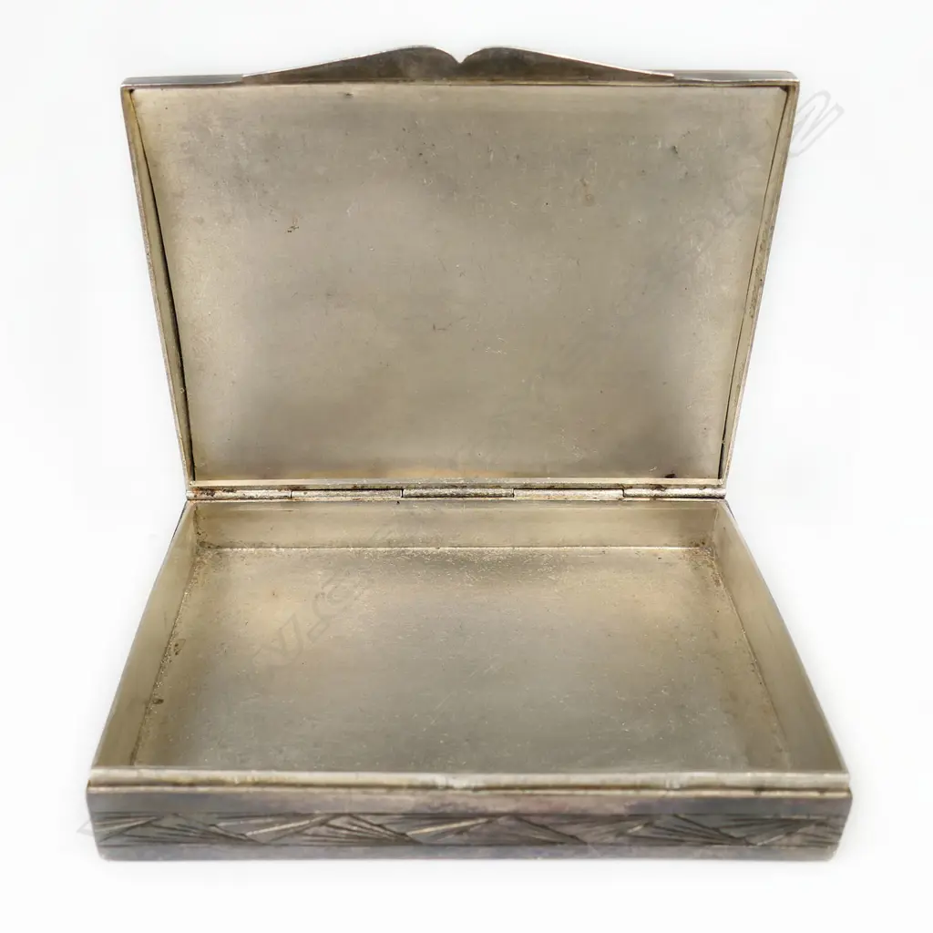 An early 20thC decorative silver box - the lid with elaborate fret cut reed, foliate and bird decorated scene jewelled with marcasite's (minor losses) and pink stones on black probably silk ground, geometric engraved Art Deco style decoration. 80 x 60 x 15mm. 118gms. Image 1++