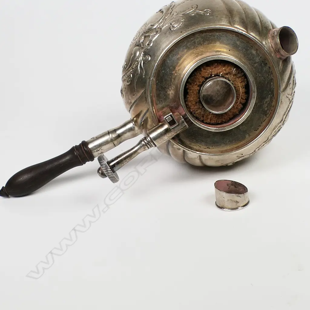 A 19thC European embossed silver table lighter - with floral and scroll framed cartouche and wrythen lobed spherical body. Adjustable wick and turned wood handle. Typically for lighting of cigars. H.65mm. Image 1++