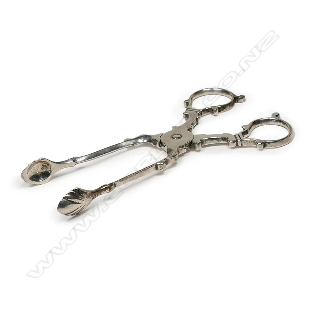 An Edwardian silver pair of Georgian style sugar scissor nips - shell bowls. London 1902 by William Hutton & Sons Ltd. 32gms. Image 1++