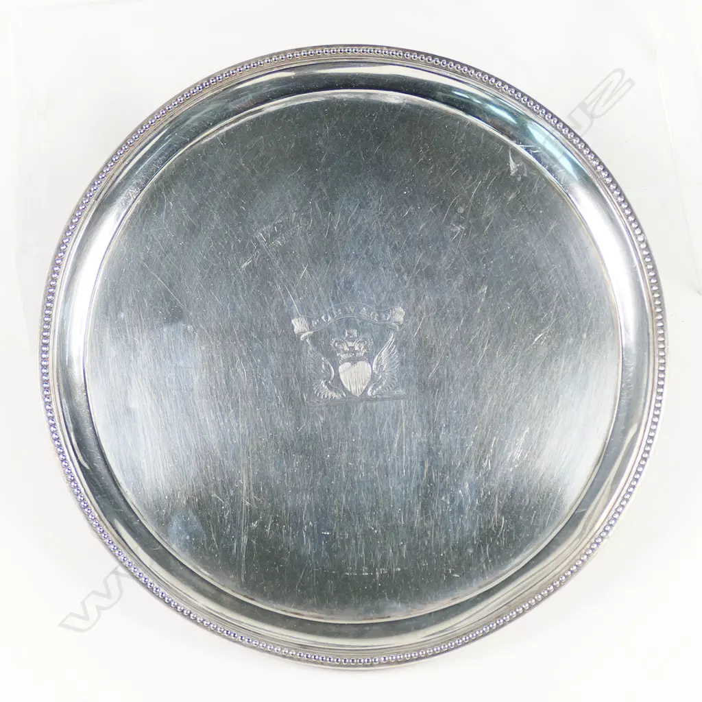 A George III silver waiter, by Peter and Anne Bateman, London 1791 - with bead edged cavetto rim, raised on three splay feet. Engraved with a crest: a winged heart gules ensigned with a sovereign’s crown beneath a banderole with the motto 'Forward'. 200gms. Dia.175mm, Image 1++