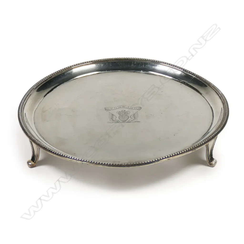 A George III silver waiter, by Peter and Anne Bateman, London 1791 - with bead edged cavetto rim, raised on three splay feet. Engraved with a crest: a winged heart gules ensigned with a sovereign’s crown beneath a banderole with the motto 'Forward'. 200gms. Dia.175mm, Image 1++