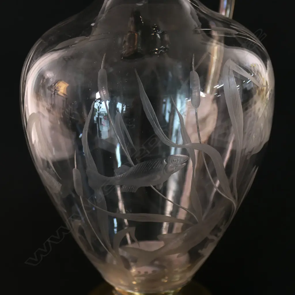 A silver and decorative fish themed cut glass wine ewer - with silver hinged lid, top mount with spout and handle. London 1876 by Jane Brownett & Alexander Jones. The ovoid body finely engraved with fish amongst reeds. On after market period brass steeped foot. H.340mm. Image 1++