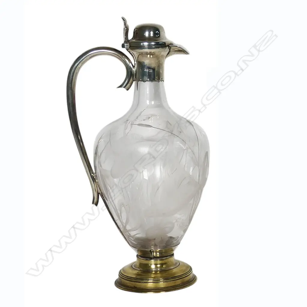 A silver and decorative fish themed cut glass wine ewer - with silver hinged lid, top mount with spout and handle. London 1876 by Jane Brownett & Alexander Jones. The ovoid body finely engraved with fish amongst reeds. On after market period brass steeped foot. H.340mm. Image 1++