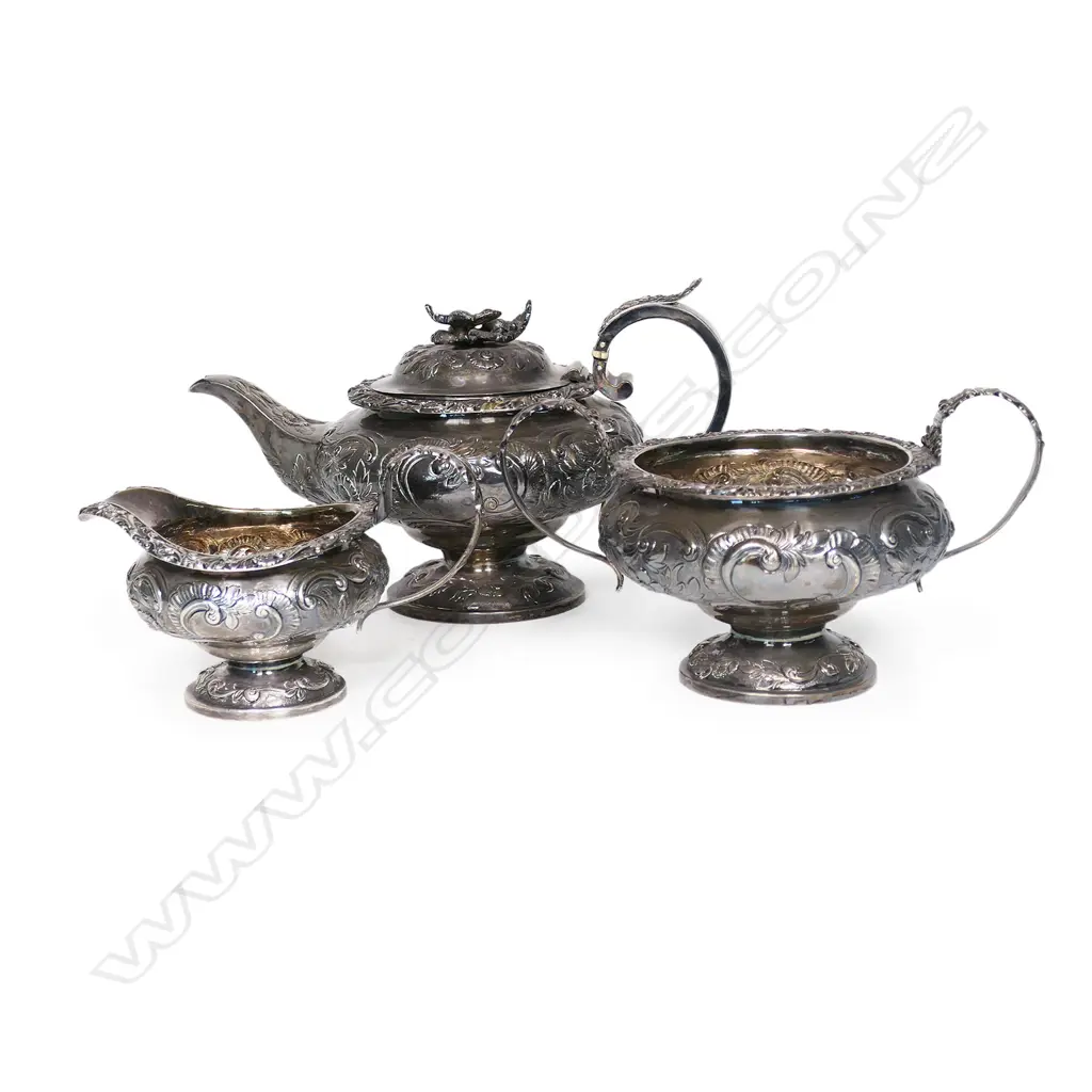 A William IV silver three-piece tea set, by Thomas Dick, London 1826 - compressed circular form raised on domed pedestal bases, chased and engraved with floral designs, the pot lid with floral finial. Total 1466gms. Image 1++