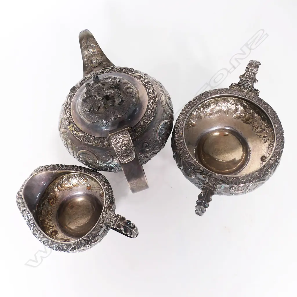 A William IV silver three-piece tea set, by Thomas Dick, London 1826 - compressed circular form raised on domed pedestal bases, chased and engraved with floral designs, the pot lid with floral finial. Total 1466gms. Image 1++