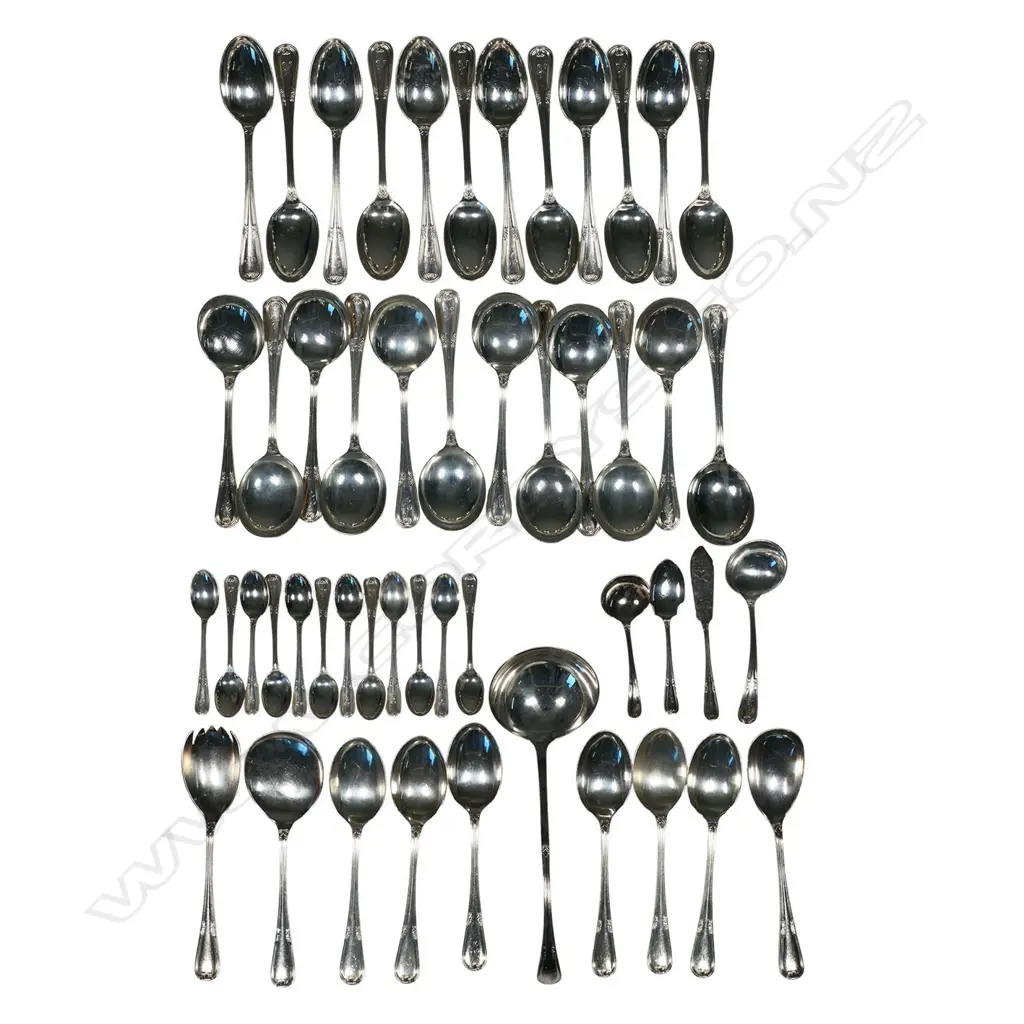 A 12 place 90-piece silver cutlery canteen by Walker and Hall, with eight additional silver plated serving utensils, Sheffield 1972 - double struck leaf and berry pattern with thread edge. Comprising 12 each: table forks, entree forks, dessert spoons, soup spoons, teaspoons, with six table spoons and 12 silver handled stainless bladed table knives and 12 entree knives. Total weight excluding knives 4255gms. Image 1++