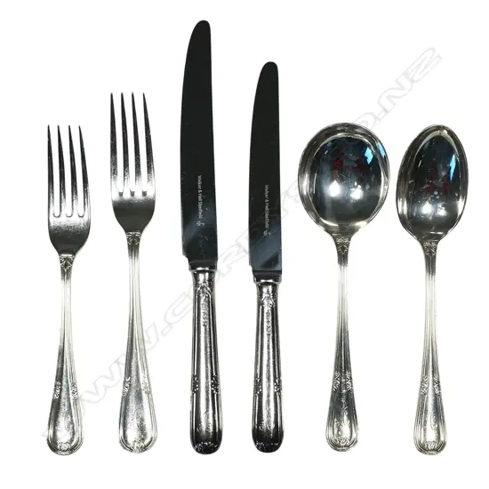 A 12 place 90-piece silver cutlery canteen by Walker and Hall, with eight additional silver plated serving utensils, Sheffield 1972 - double struck leaf and berry pattern with thread edge. Comprising 12 each: table forks, entree forks, dessert spoons, soup spoons, teaspoons, with six table spoons and 12 silver handled stainless bladed table knives and 12 entree knives. Total weight excluding knives 4255gms.