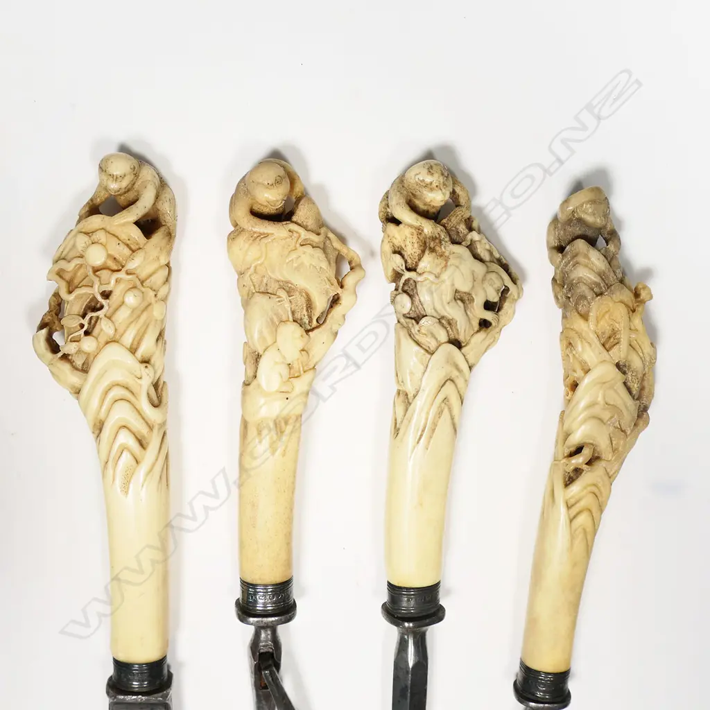 A Victorian silver mounted steel and Japanese carved bone handled carving set - the four pieces: knife, two forks and steel each with a carved bone handle featuring a monkey to the top and other animals and snake etc. One small loss. The collars Sheffield 1886 by William Yates a noted flatware and handle maker. Together with an old note about the set. Image 1++