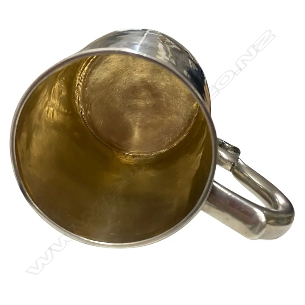 A rare and early George I silver mug -the plain body with an elaborately framed cartouche enclosing scripted initials. Double scroll handle. H.110mm. London 1716 by William Fleming a noted mug maker. 296grms. Image 1++