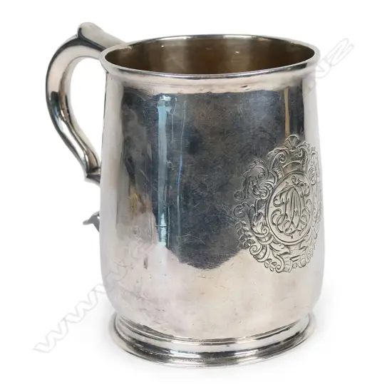 A rare and early George I silver mug -the plain body with an elaborately framed cartouche enclosing scripted initials. Double scroll handle. H.110mm. London 1716 by William Fleming a noted mug maker. 296grms.