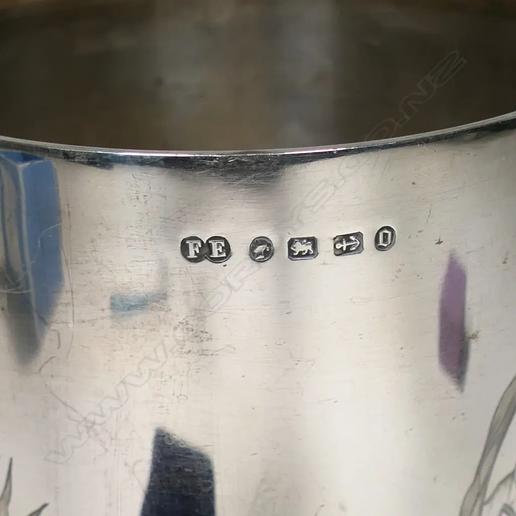 A New Zealand historical silver trophy cup - engraved 'Presented by The New Zealand Loan & Mercantile Agency Company To T.G. Smith, Wells Hill. For Best Pen 5 Merino Ewe Hoggets. Blenheim. 27th Nov. 1889'. Engraved to the front with a colonial mountain and pastoral landscape with sheep and a cow. H.235mm. 308gms Image 1++